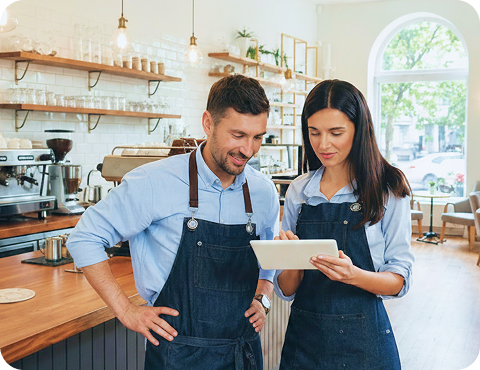 Restaurant owners checking orders on a tablet